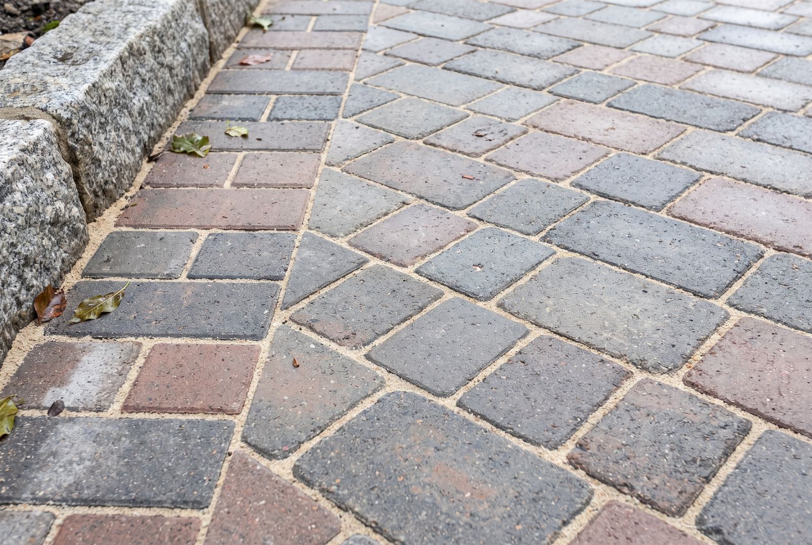 Close up detail of newly laid block paving with a soldier course edge