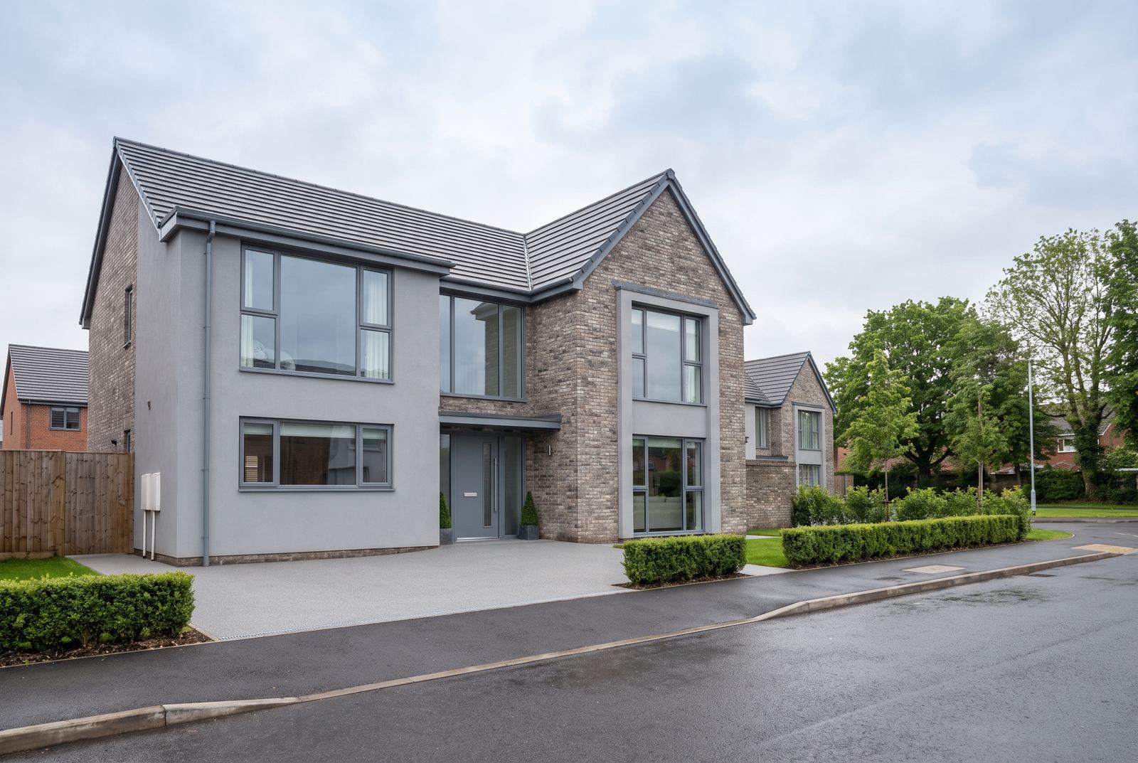 A smooth silver grey resin bound driveway at a modern British home