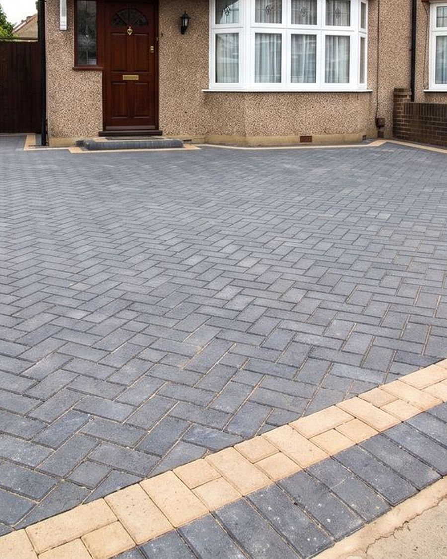 A charcoal herringbone block paving driveway at a 1930s semi detached house